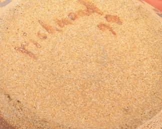 Closeup of geometric pattern stoneware jar with wood handled lid