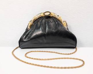 A fabulous Judith Lieber black leather evening purse with ornate Swarovski crystal clasp and gold tone chain strap