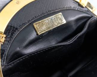 Closeup of the fabulous Judith Lieber black leather evening purse with ornate Swarovski crystal clasp and gold tone chain strap