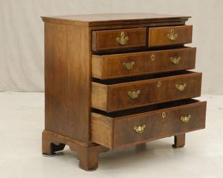 18th Century Georgian Burled Walnut Chest of Drawers Featuring five drawers and simple ogee bracket feet. Bookmatched burled veneer on top surface with inlaid marquetry border; drawer fronts with inlaid strips framing burled wood veneer. Brass escutcheons with swan neck handles.