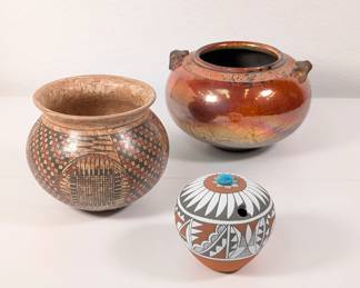 A Jemez Pueblo Native American pottery seed pot by Mary Small, a Southwestern geometric pattern painted gourd style jar, and a beautiful handpainted and iridescent glaze two-handled art pottery jar signed by the artisan.