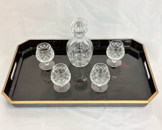 A Japanese lacquered tray, with four Brierly for Cartier cut crystal brandy or cognac snifters, and a stoppered cut crystal carafe
