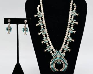 This vintage squash blossom necklace with matching earrings is a wonderful exemplar of vintage needlepoint turquoise and silver work from Zuni silversmith Terry Loncasion, an artisan widely known for their needlepoint jewelry.