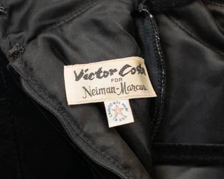 Closeup of Victor Costa for Neiman Marcus black velvet belted peplum top with fox fur trim, and black pencil skirt set