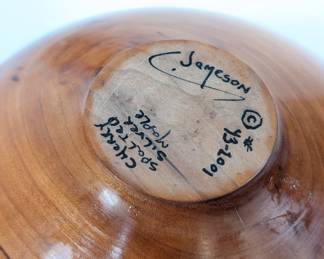 Closeup of base of the polished segmented turned wood vase of cherry wood and spalted silver maple signed and numbered by artist C. Jameson