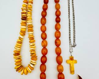 Amber bead necklaces, pair of amber earrings, and a sailboat shaped carved amber brooch