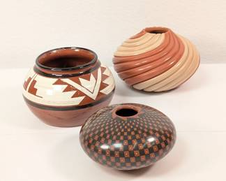 A vintage wheel-thrown hand painted Sioux pottery vase signed by Al Black Tail Deer; a Jemez Pueblo pottery small two clay coiled polished bowl signed by Native American artist Marcella Yepa; and a hand painted geometric pattern pottery vase signed Guadalupe Ledezma Quezada, second-generation potter in Mata Ortiz in Chihuahua, Mexico