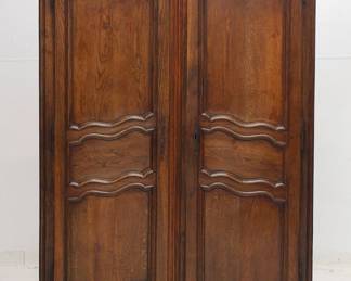 A French 19th Century carved wooden two door cupboard or armoire with internal shelving and two drawers