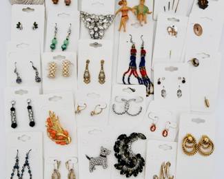 Variety of styles of vintage costume jewelry earrings, stick pins, brooches, and more