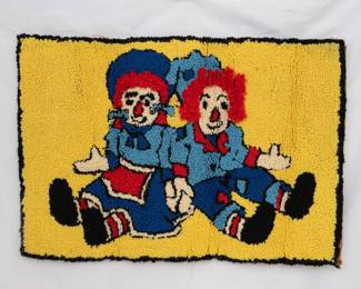 A vintage Raggedy Anne and Andy latch hook rug