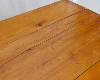 A closeup view of the vintage drop leaf table