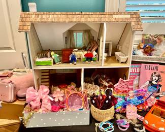 Dollhouse with dolls and furniture.