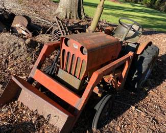 Economy Tractor with front end loader and implements.  Was running when parked some years ago.  Probably needs battery to crank.