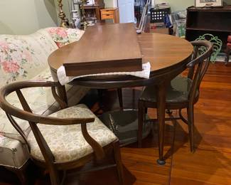 Wood dining table with one leaf and three chairs.  Perfect condition for its antique age.