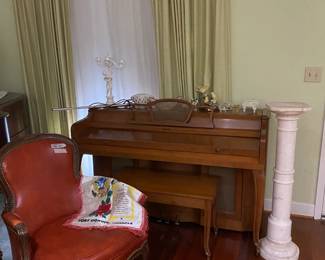Beautifully tuned console piano.  Marble plant stand, beautiful what knots and a fine leather chair.