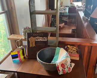 Antique bowl and cloth, vintage clock, Danti's Inferno, vintage napkin rings, along with a wooden shelf, and on top, vintage or antique cast iron doorstops featuring two Scottish Terrier dogs, commonly known as Scottie dogs! 