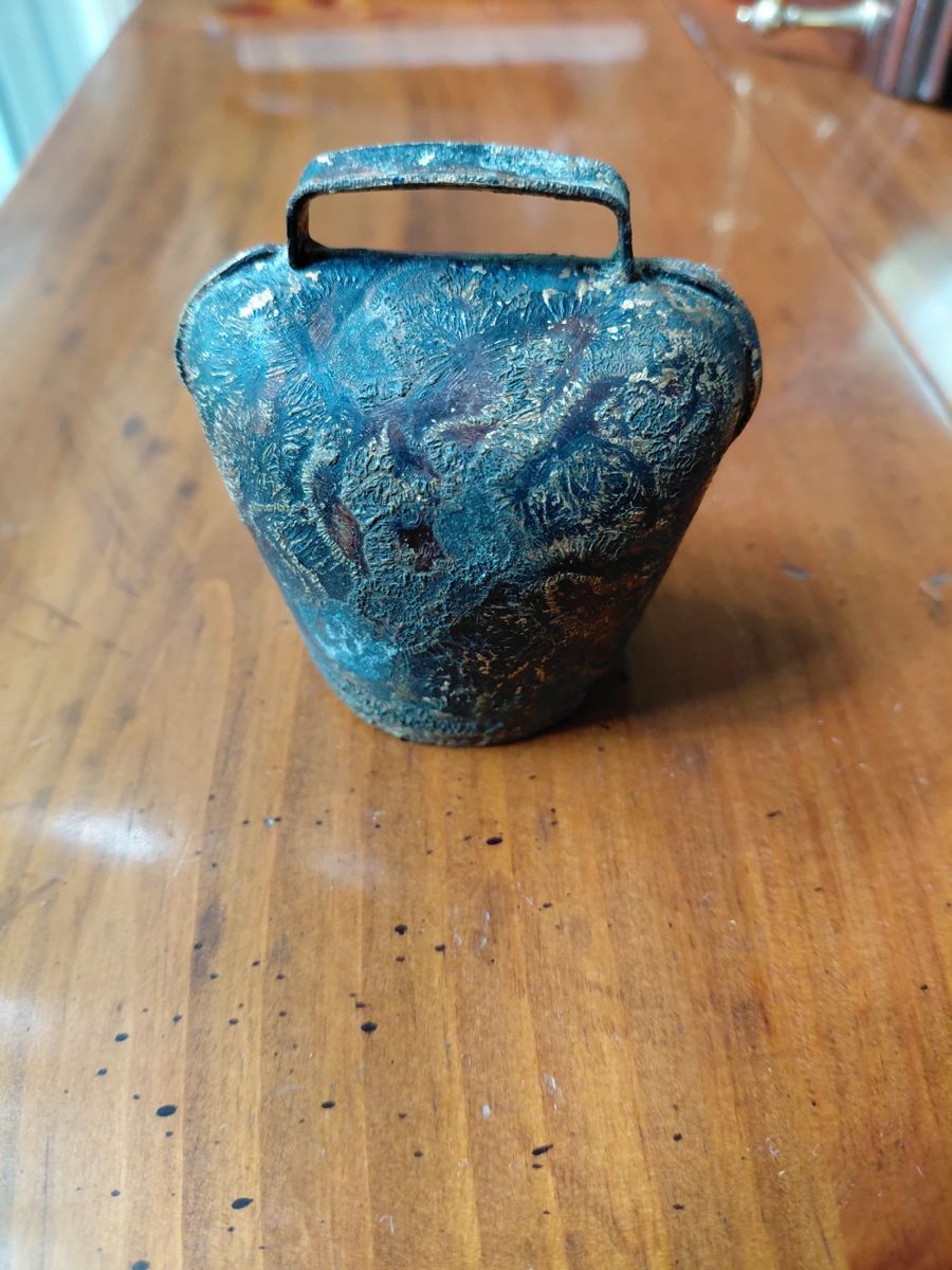 Metal bell with design.