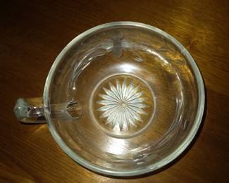 Flower etched candle votive.