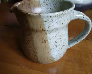 Pouring pottery mug.