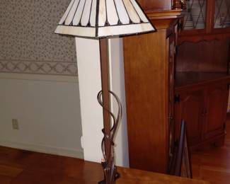 Tall skinny table lamp with stained glass shade.