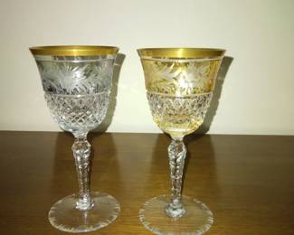 Colored Crystal glasses (2), one is gold and the other is blue.