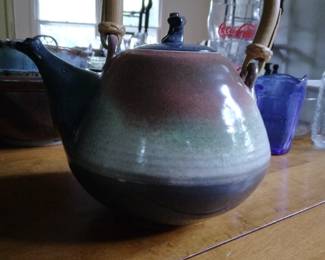 Pottery colorful tea pot with handle.