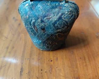 Metal bell with design.
