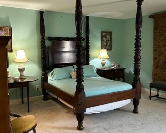 19th century African carved four post bed. The couples parents purchased this bed directly on one of their many trips to Africa.