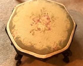 Antique needlepoint footstool.  There are a variety of sizes and shapes all over this house.