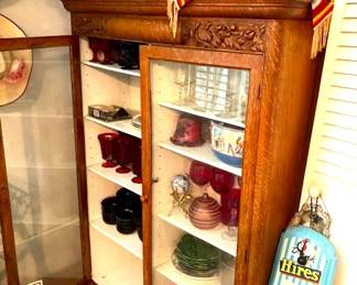 Antique oak storage cabinet with glass front doors.