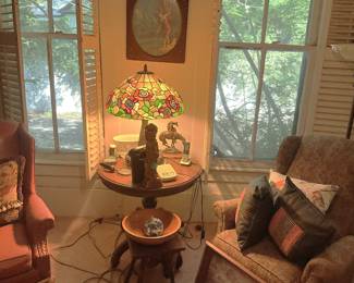 Round oak side table, Tiffany lamp and western art.