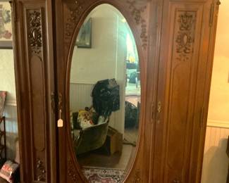 Antique French walnut armoire with large oval beveled mirror.  Stunning!