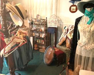 Dress stand, oval bow-front frame, hats and hat tree.