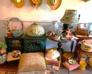 Tiffany lamps, iron fireplace insert and cowboy hats.