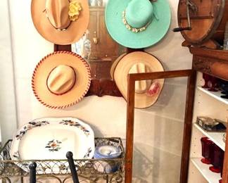 Vintage men and women's cowboy hats, oak mirrored wall hanging with hat hangers, lark platter and oak butter churn.