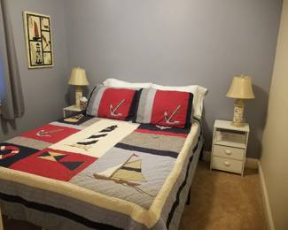 Queen bed; charging nightstands; table lamps; metal artwork