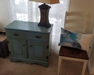One-drawer cupboard; dining chair; table lamp