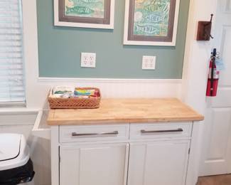Chopping block cupboard on wheels; artwork