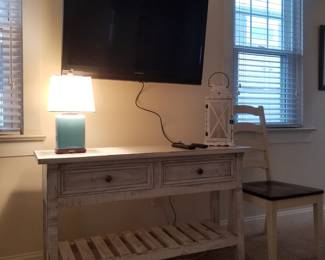 2-drawer console; TV with mounting bracket; table lamp; decorative lantern