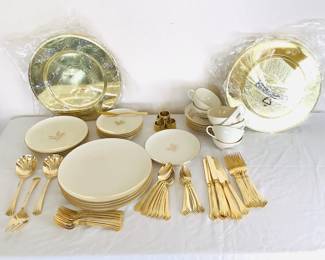 "Wheat" by Lenox set of (7) teacups and (7) matching saucers, (5) dinner plates, (4) salad plates, (6) bread plates and more. Most plates show signs of wear with fading of the gold emblem and utensil marks. No chips or cracks. Set of Rogers stainless steel gold toned flatware, service for (8). Four gold toned napkin rings and (8) gold toned chargers.