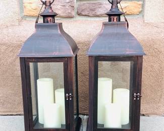 New Candle Impressions pair of metal lanterns with a trio of flameless candles inside. Untested. H 22" x 9 1/2" square.