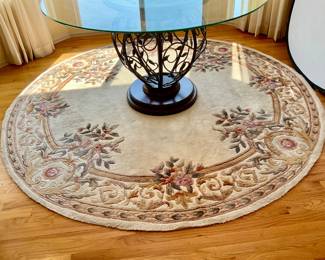 Oriental style Momeni round rug. 93" diameter. Table not included.