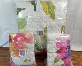 New pink floral quilted bedding, machine made. Includes (2) shams. Sealed in bag and therefore cannot verify size. Assume king based on other bedding from consignor. Made in China.