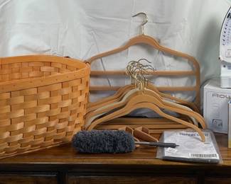 New Rowenta 'Effective" iron, model DX 1920. Includes original box and instructions. New Black and Decker "Quickpress" iron, model AS75. Includes original box and instructions. Large woven laundry basket, unmarked. H 10" x W 24" x D 17".