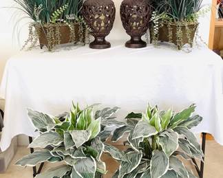 Four (4) faux greenery plants, each approximately H 25". Two ceramic candle holders with electric candles, H 16" x 8" diameter.