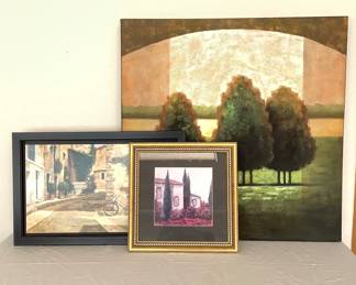 A trio of Italian landscape art prints. One canvas wrapped featuring (3) trees, 30" square. Print on board of bicycle scene with a wood frame, H 15" x W 23". Framed print of a villa and trees, 14" square.