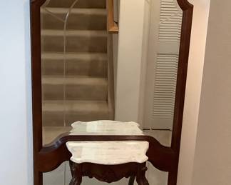 Hall half table with mirrored backing. No manufacturer found. H 80" x W 38" x D 12". Cherry wood finish. Faux marble top.