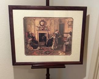 Cherry wood toned art display rack, adjustable. Shown dimensions H 59" x W 15" x D 15". Vintage Currier and Ives print of a family gathered around the piano. H 24" x W 30".