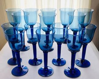 Eight (8) large hand blown glass cobalt blue goblets, H 9 1/2" x 4" diameter. Seven (7) matching wine glasses, H 9" x 3 1/2" diameter.