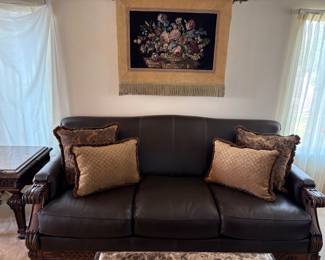 Lane faux leather sofa featuring a classical, wood carved frame. Excellent condition. H 38" x W 88" x D 39". Matches lots 95 and 96. Receipt from consignor shows Lane as the brand of furniture.